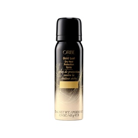 Oribe Gold Lust Dry Heat Protection Spray in a black and gold travel-size aerosol can with gold foil detailing