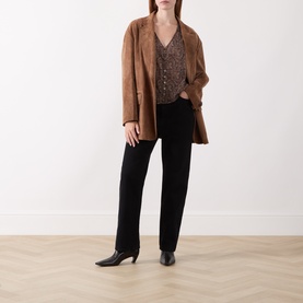 Model wearing Paige Dark Brown Multi silk blouse with camel longline blazer, black straight-leg trousers and black heeled boots.