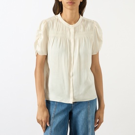 Model wearing Paige Antique White top with pintuck pleating, puff sleeves and button front, styled with blue wide-leg jeans
