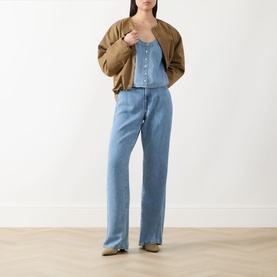 Model wearing Paige top in Palos Verdes denim, styled with tan knit cardigan and matching wide-leg denim trousers.