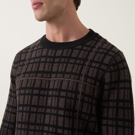 Model wearing Tiger of Sweden crew neck jumper in Dusty Brown Melange, check jacquard pattern, black ribbed collar, merino wool blend