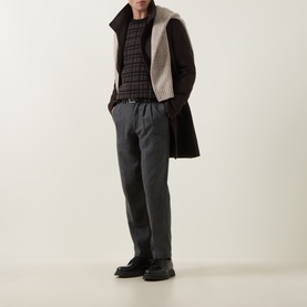 Model wearing Tiger of Sweden Dusty Brown Melange merino wool crew neck, styled with dark gilet, grey trousers and black loafers.