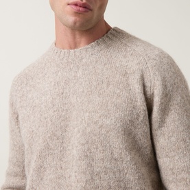 Model wearing Tiger of Sweden stone crew neck knit in yak, alpaca and wool blend, close-up showing texture detail
