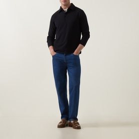 Model wearing Tiger of Sweden Night Sky wool polo with blue jeans and brown leather loafers