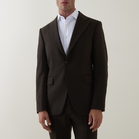 Model wearing Tiger of Sweden 1903 Single-Breasted Blazer in coffee, peaked lapels, flap pockets, styled with white shirt and brown trousers