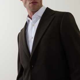 Model wearing Tiger of Sweden 1903 Single-Breasted Blazer in coffee, peaked lapels, styled with a white shirt.