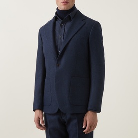 Model wearing Tiger of Sweden Easer Single-Breasted Suit Jacket in Sea, styled with matching trousers and dark rollneck underneath.