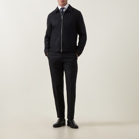 Model wearing Tiger of Sweden Blue Function wool-blend suit jacket with zip front, styled with white shirt and black trousers