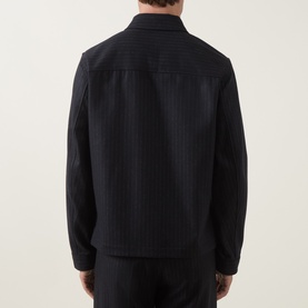 Model wearing Tiger of Sweden Blue Function Suit Jacket, rear view, wool-blend pinstripe fabric, relaxed structured fit