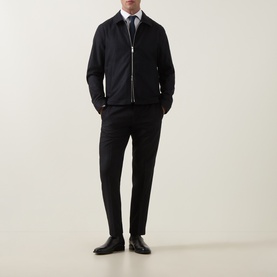 Model wearing Tiger of Sweden Blue Function Suit Jacket with matching trousers, white shirt, tie and black leather shoes