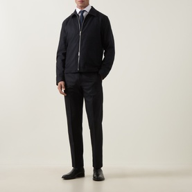 Model wearing Tiger Sweden Blue Funcrion Suit Trousers in wool blend, styled with dark zip jacket, light shirt and black shoes.