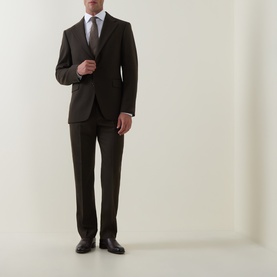Model wearing Tiger of Sweden Tenser Slim Suit Trousers in Coffee, styled with matching slim-fit jacket, white shirt, tie, and black shoes.