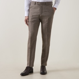 Model wearing Tiger of Sweden Blurywood wool suit trousers, styled with dark brown leather Oxford shoes and a white shirt.