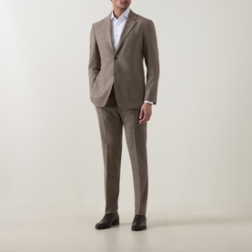 Model wearing Tiger of Sweden Blurywood wool suit trousers with matching jacket and white shirt, styled with dark brown leather shoes