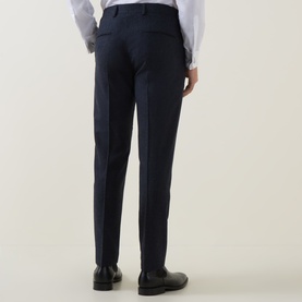 Model wearing Tiger of Sweden Midnight Blue suit trousers, rear view, styled with black leather Oxford shoes and white shirt.