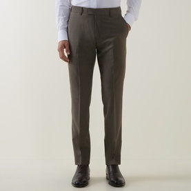 Model wearing Tiger of Sweden stone suit trousers with slim fit, styled with a white shirt and black leather shoes.