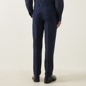 Model wearing Tiger of Sweden Suit Trouser in Sea navy, rear view, with matching suit jacket and black leather shoes.