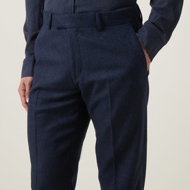 Model wearing Tiger of Sweden Suit Trouser in Sea blue, wool-blend fabric, tailored fit with front pleat detail and side pockets.