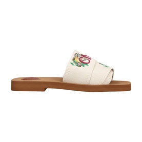 Chloe yellow canvas slide sandal with floral embroidery on strap and tan flat sole
