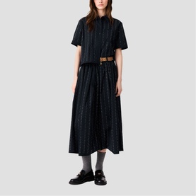 Model wearing Maje Womens French Dress in multicolour stripe, styled with a tan belt and black loafers