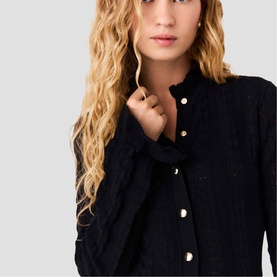 Model wearing Maje Womens French Dress in red, black boucle-style fabric with gold buttons, close-up detail shot