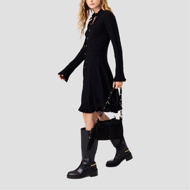 Model wearing Maje Womens French Dress in red, styled with black knee-high boots and carrying a black bag with floral detail.