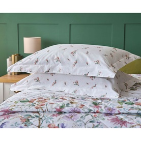 Belledorm Cleo Oxford Pillowcase Pair Multi, white with floral and bee print, shown on a made bed with matching duvet