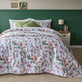 Belledorm Cleo Oxford Pillowcase Pair Multi, floral print in pink, purple and green on white, shown styled on a made bed with matching duvet
