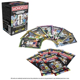 Monopoly FIFA World Cup edition box with fan of trading cards and sealed card packs displayed in front, multi-coloured design