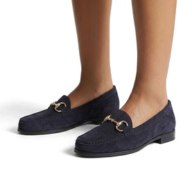 Model wearing Carvela Comfort blue suede loafers with gold-tone horsebit hardware and flat sole