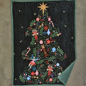 Deyongs navy Christmas tree throw with festive embroidered nutcrackers, ornaments and star topper, shown flat with sage green reverse visible.