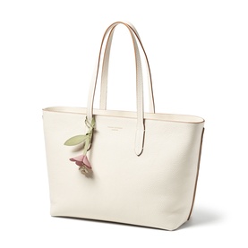 Aspinal of London ivory leather tote bag with twin top handles, tan trim, and pink floral charm detail