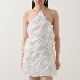 Model wearing Elliatt white halterneck mini dress with layered ruffle and sequin embellishment detail throughout
