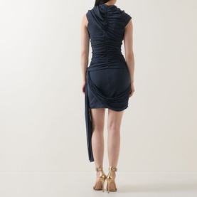 Model wearing Elliatt Marisol Ruched Top & Skirt Set in charcoal, rear view showing draped ruched detail and asymmetric hem, styled with gold heeled