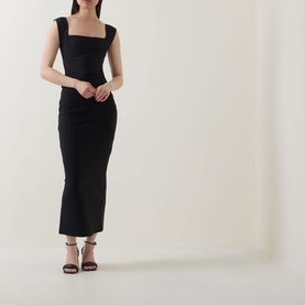 Model wearing Elliatt black sleeveless square-neck midi dress with ruched bodycon silhouette, styled with dark strappy heeled sandals.