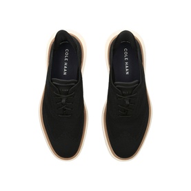 Cole Haan black suede lace-up Oxford shoes, top-down view showing tan rubber sole contrast and tonal laces.