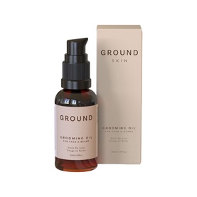 Ground Skin Grooming Oil for Face & Beard in dark amber pump bottle with matching product box