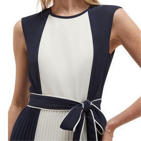 Model wearing Hobbs midnight ivory colour-block sleeveless dress with pleated skirt panel and tied bow belt detail.