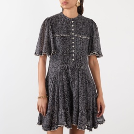 Model wearing Isabel Marant Etoile black and ecru cotton mini dress with flutter sleeves, button front, smocked waist and floral print.