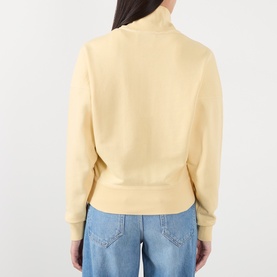 Model wearing Isabel Marant Etoile yellow sweatshirt, back view, with funnel neck and ribbed hem, styled with light blue jeans.