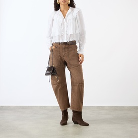 Model wearing Isabel Marant Etoile white cotton blouse with ruffle detail, styled with brown cargo trousers, ankle boots and mini bag.