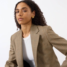 Model with Jenny Bird Square Woven Earrings in gold-toned 14K plated steel, square shape with polished finish, styled with a checked blazer