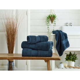 Karla Bree Portobello Towel in Petrol, a set of four folded and hanging 100% cotton towels styled in a bathroom setting.