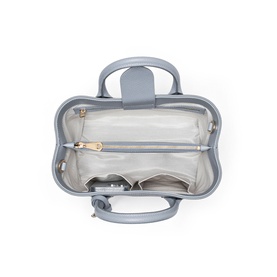 Aspinal of London sky blue bag, open top view showing pale grey interior lining, zip pockets, and gold-tone hardware details.
