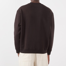 Model wearing NN07 sweatshirt in Dusky Port, rear view, crew neck, ribbed cuffs and hem, styled with cream trousers