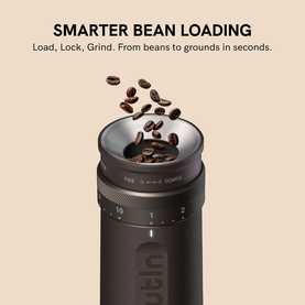 OutIn Fino Portable Electric Coffee Grinder in dark brown/black, shown with coffee beans loading into the top grind chamber.