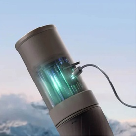 OutIn Mino Portable Espresso Machine in grey, shown with UV sterilisation light activated and USB cable attached