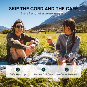 Two people enjoying espresso outdoors using the OutIn Nano Portable Espresso Machine Grey, with mountains in the background. No outlet needed.