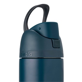Owala FreeSip 24oz Water Bottle in Winter Nights, close-up of teal insulated bottle showing flip lid, carry loop and spout detail.