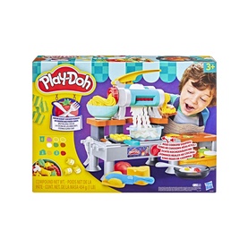 Play-Doh multicolour pasta and noodle making playset with accessories, shown with packaging and child in background